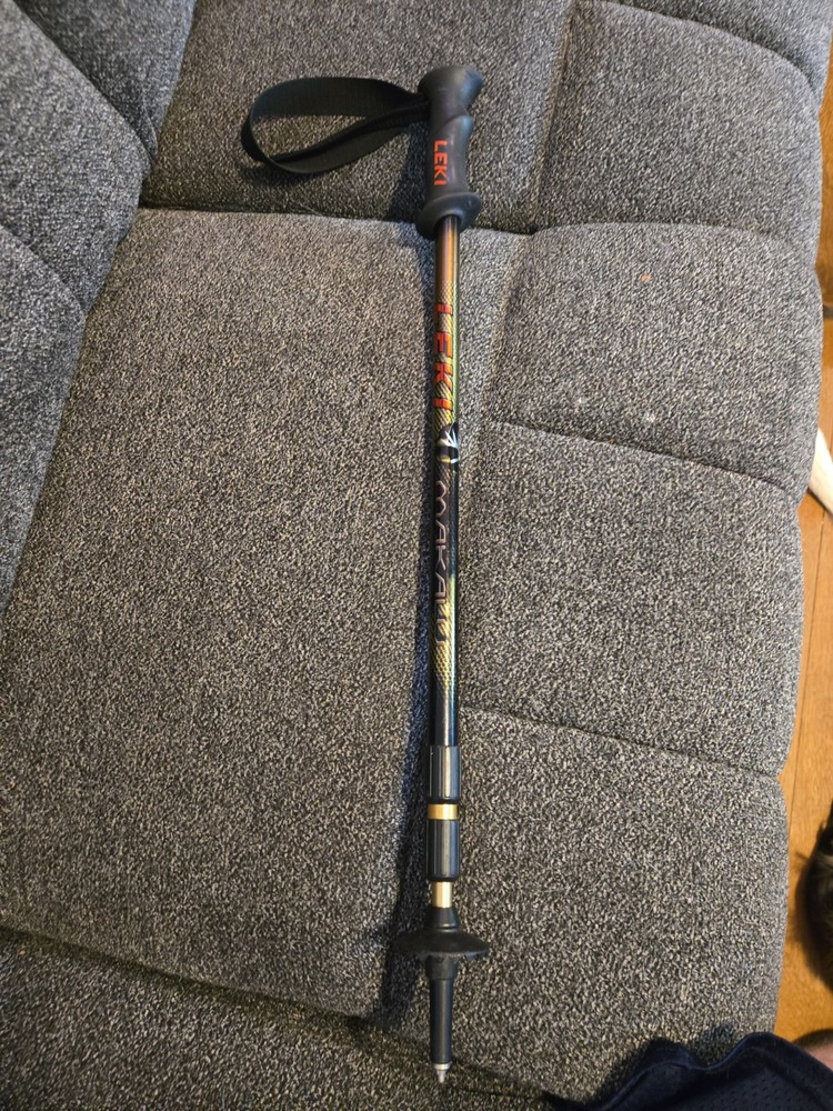 This is a Leki trekking pole featuring a black grip and an adjustable shaft.