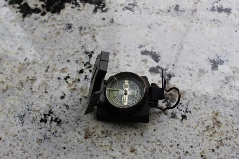 Vintage military compass folds up to compact travel size