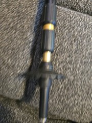 This is a Leki trekking pole featuring a black grip and an adjustable shaft.